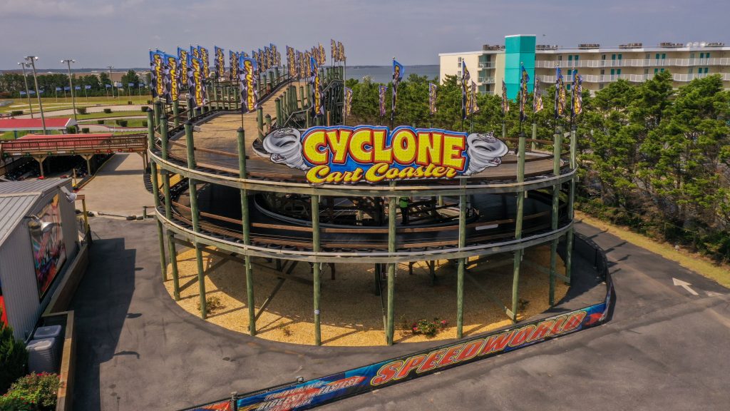 Go cart wood racetrack roller coaster with big sign that says Cyclone