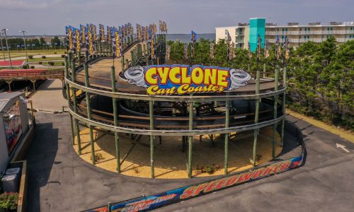 Go cart wood racetrack roller coaster with big sign that says Cyclone